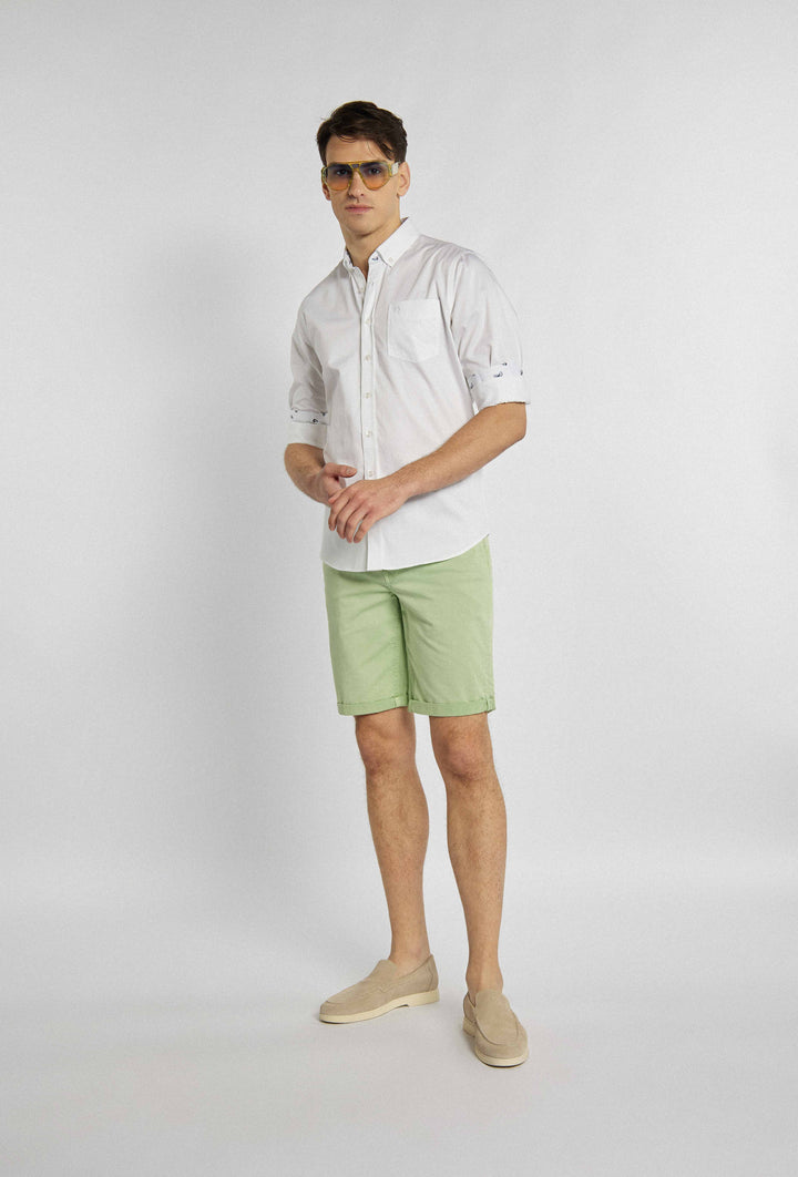 White shirt with chest pocket, brand logo and floral design