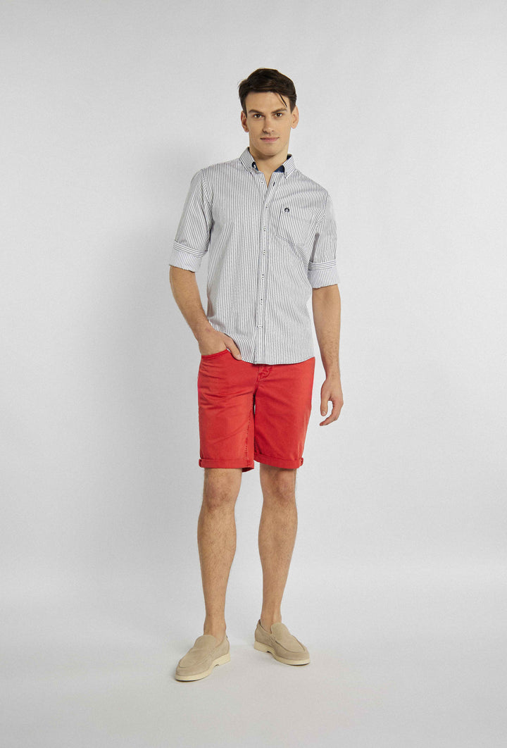 Classic shirt with thin navy blue stripes and logo on pocket