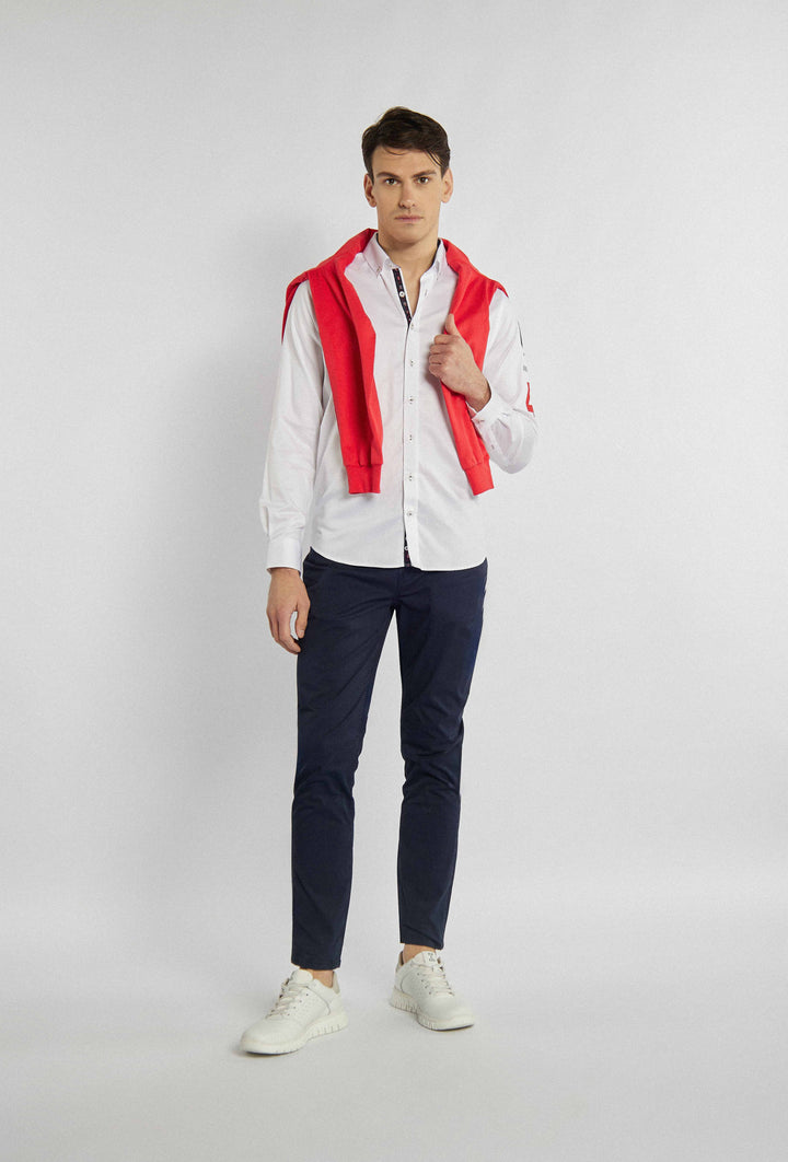 White shirt with different colored lettering on the sleeve