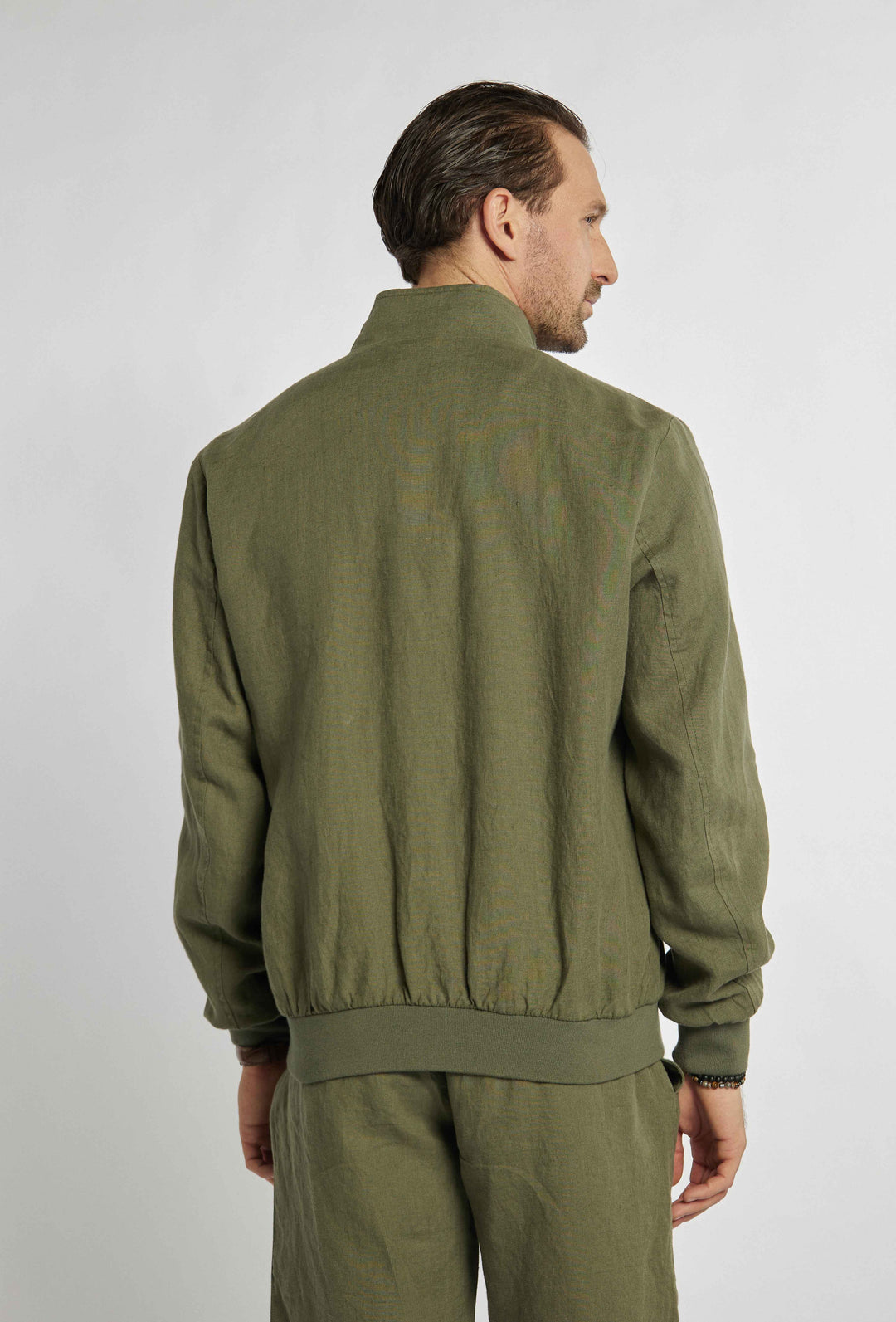 Blouse in khaki color with sigil on chest