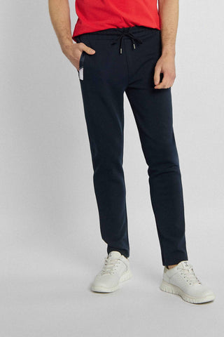 Navy blue sweatpants with white patches at pockets
