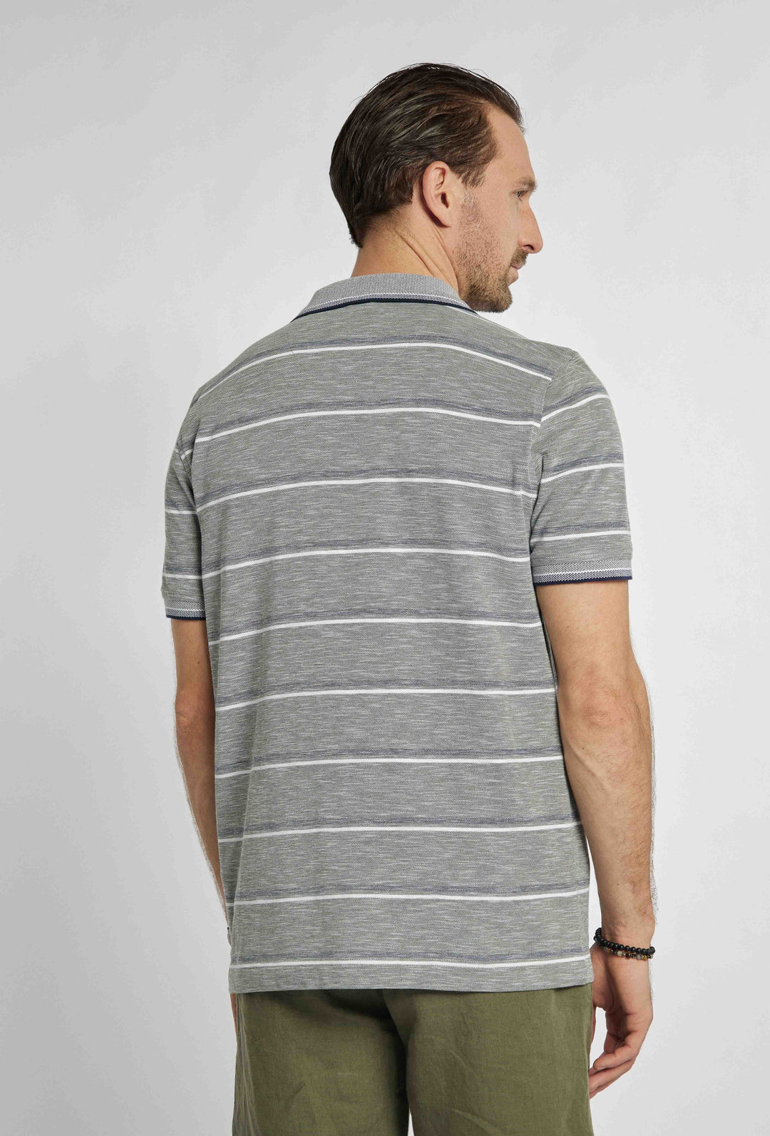 Gray polo shirt with navy and white stripes and brand logo on chest