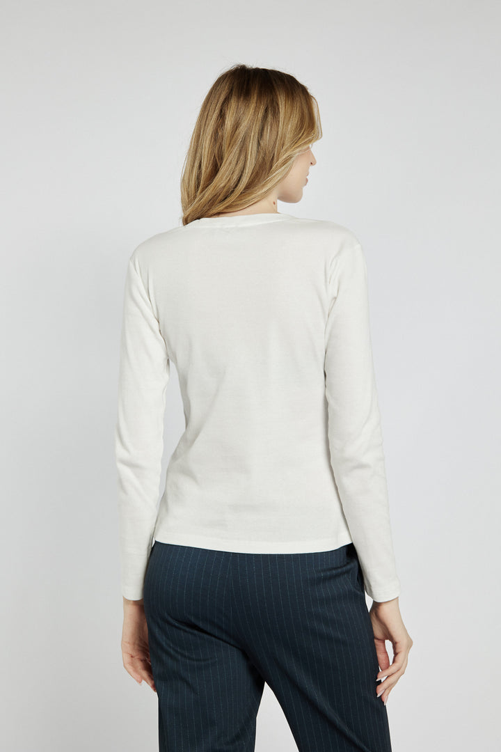 White long-sleeved top with lettering