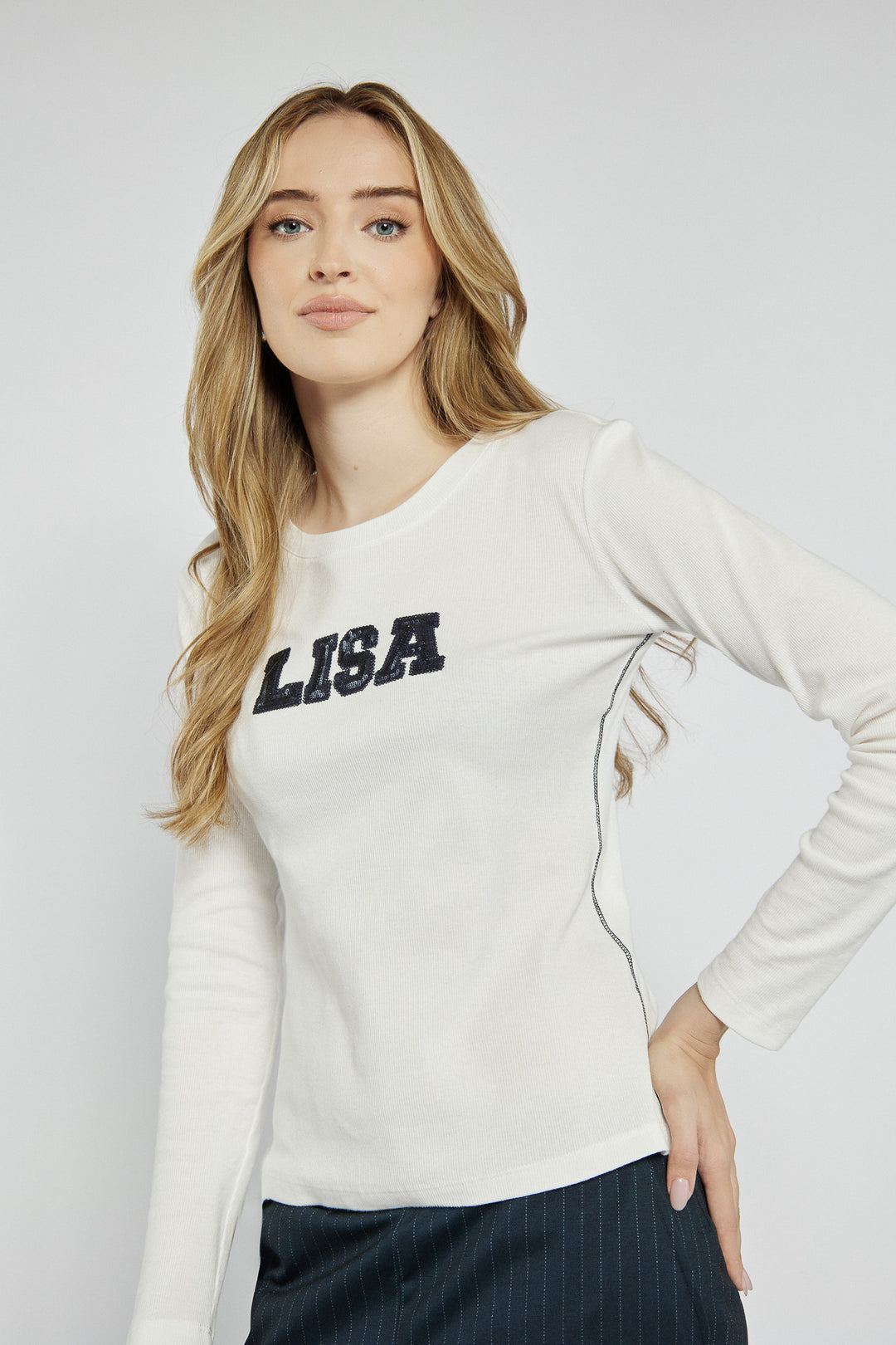 White long-sleeved top with lettering