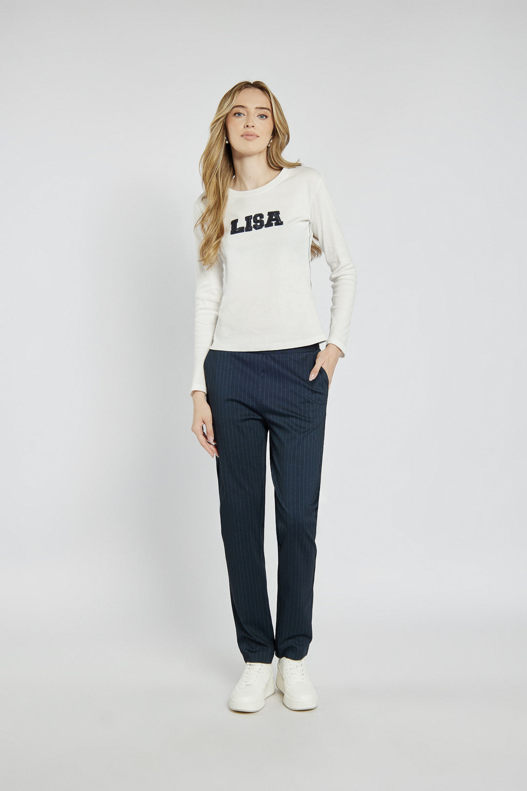 White long-sleeved top with lettering