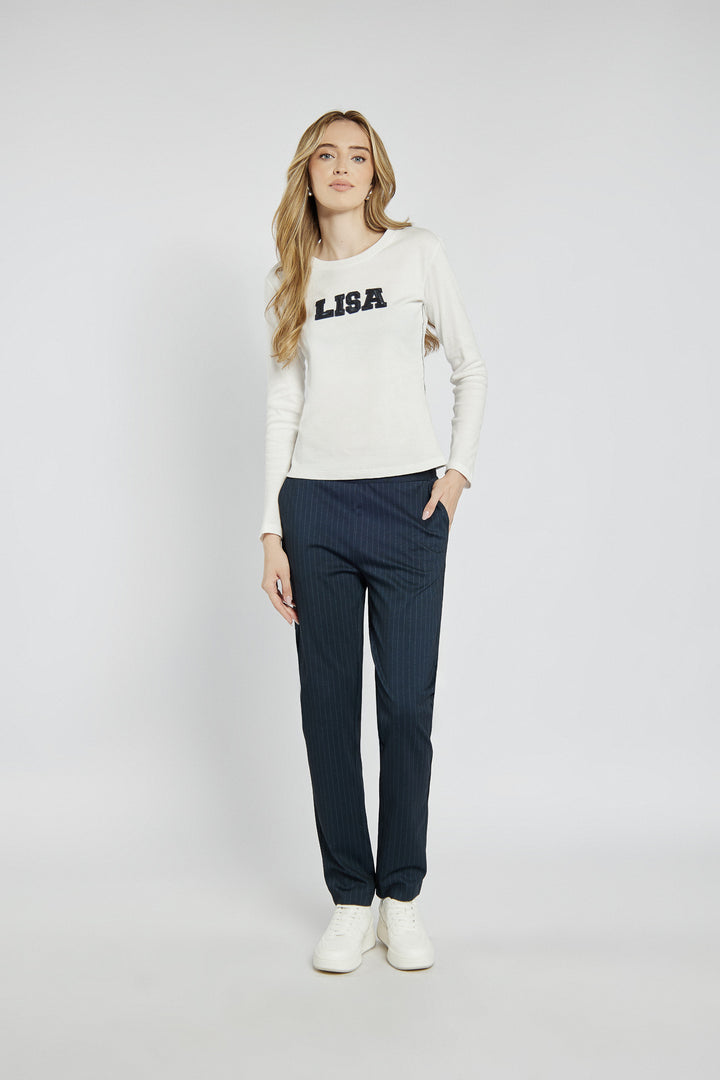 White long-sleeved top with lettering