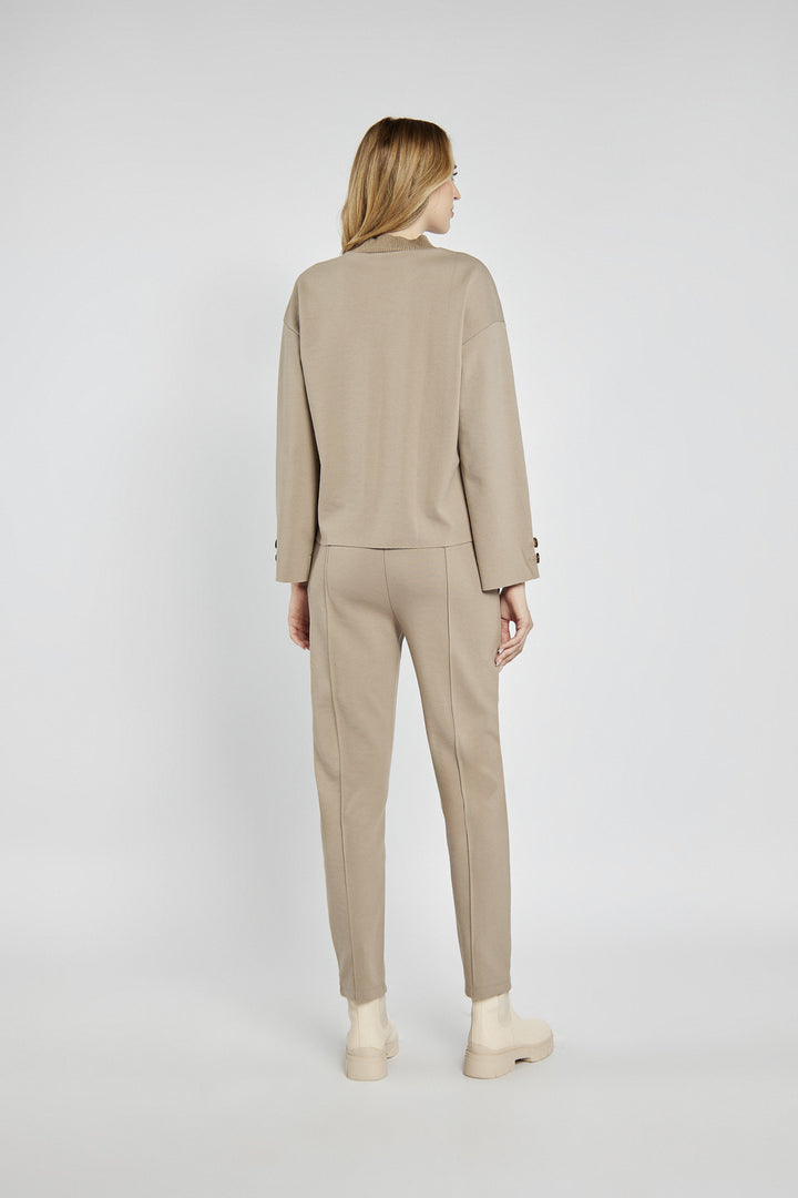 Beige women's pants with creases and an elastic waistband