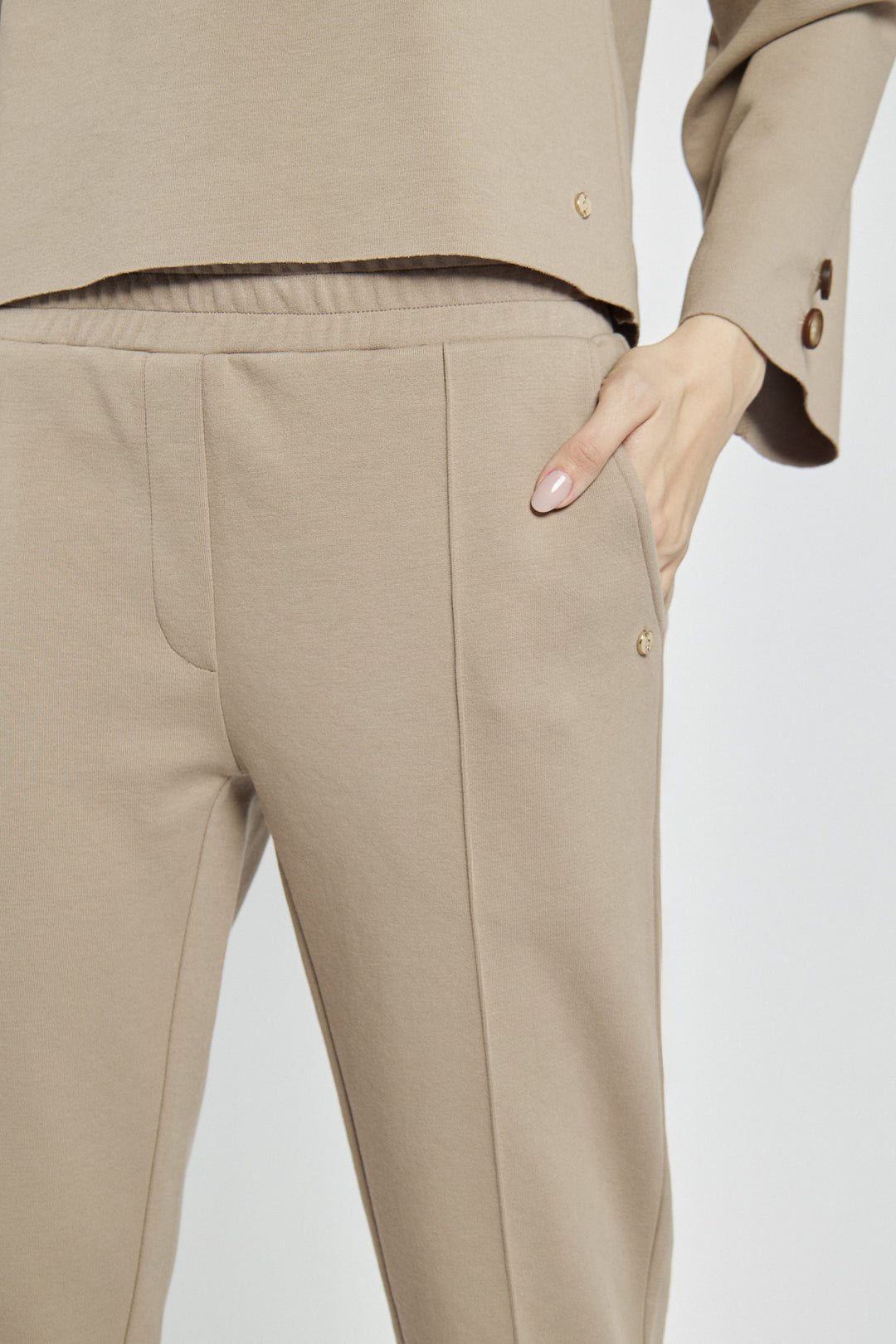 Beige women's pants with creases and an elastic waistband