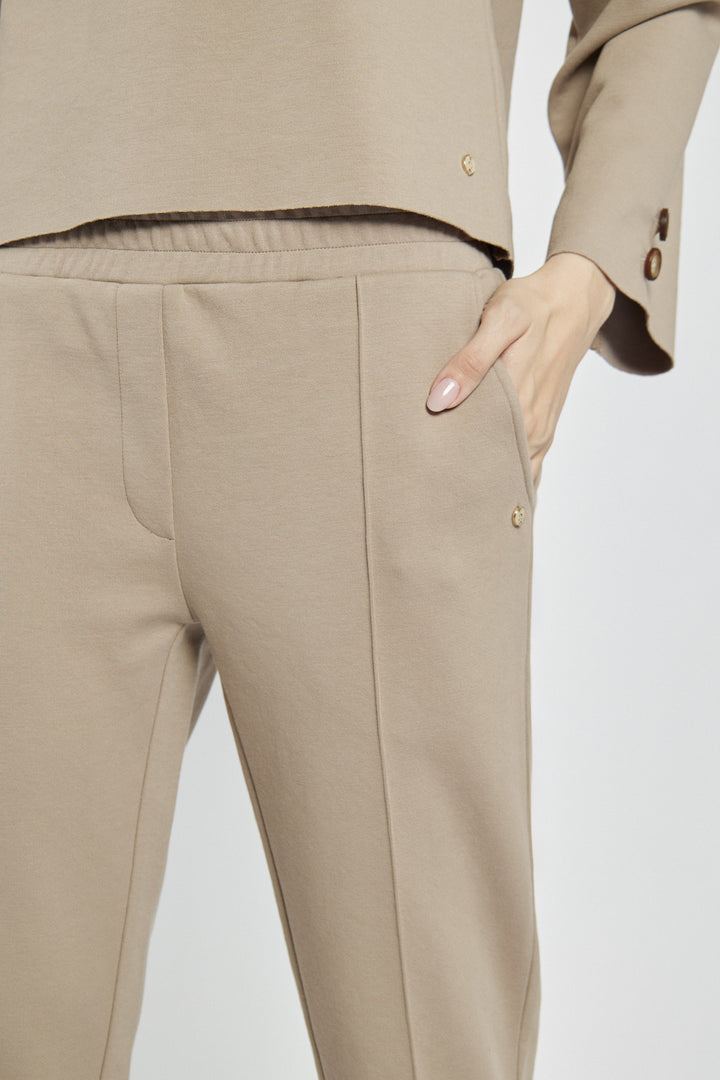 Beige women's pants with creases and an elastic waistband