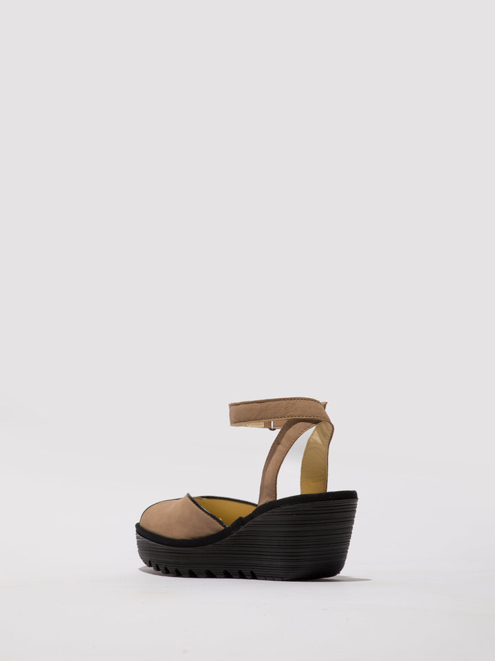 Brown Shoes with a High Wedge and Ankle Fastening